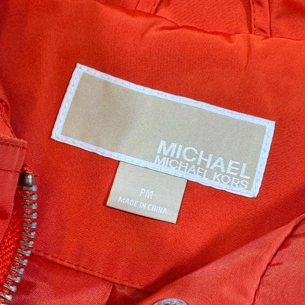 NWOT Michael Kor’s Women's Orange Hooded Rain Coat Jacket with silver details
